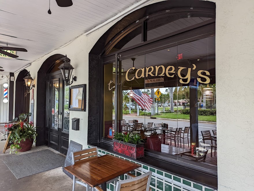 T.J. Carney's storefront on West Venice Avenue at dusk
